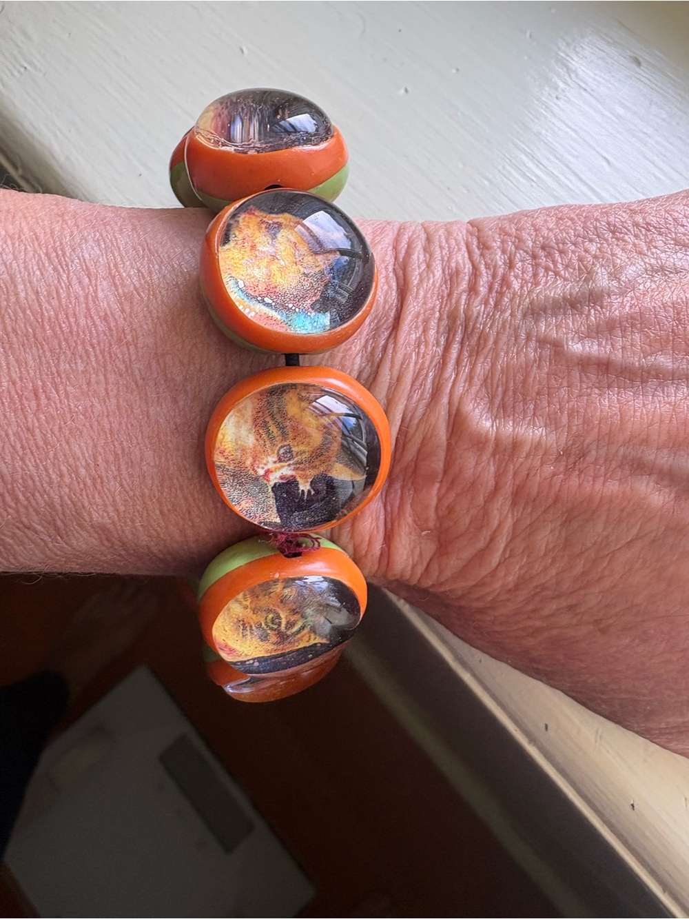 Handmade Orange & Green Dome Bracelet featuring a kitty in each bead
